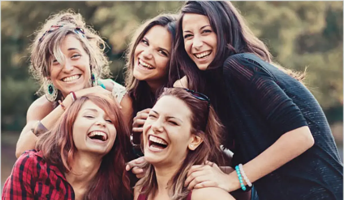 Group of friends smiling confidently, showcasing the benefits of dental bridges.