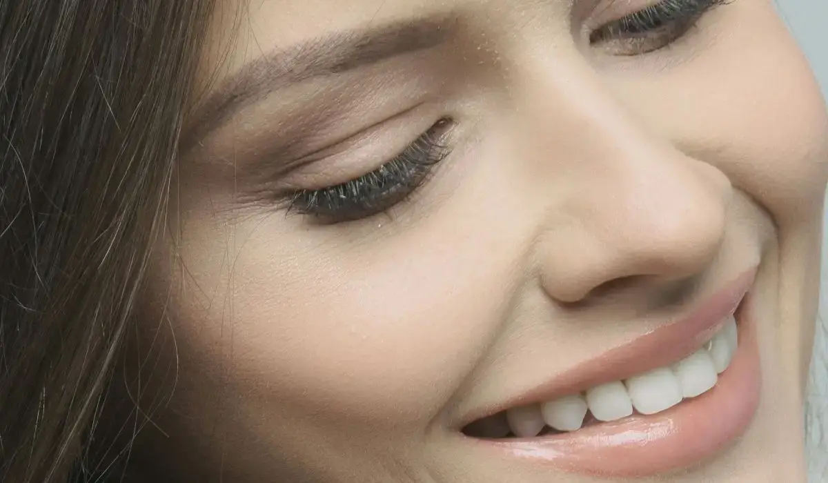 Close-up of a person smiling confidently, showcasing the results of teeth whitening.