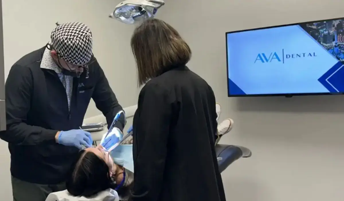 Dentist treating patient while preventing dry socket after tooth extractions in a professional dental clinic.