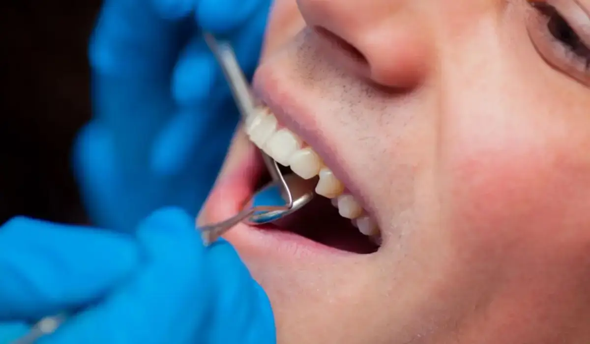Dentist carefully examining patient for knocked out teeth treatment in a professional dental clinic setting.